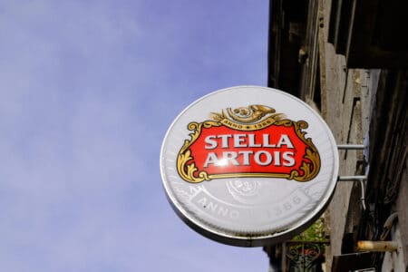 Stella Artois blade sign hanging on a historic street in Bordeaux, France, showcasing retail pub signage