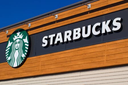Starbucks Coffee storefront sign in Truro, Canada, featuring the iconic green logo on the shop facade in November