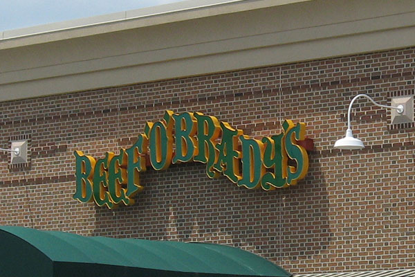Modern exterior building sign with bold lettering on a commercial facade in Aurora, Colorado.
