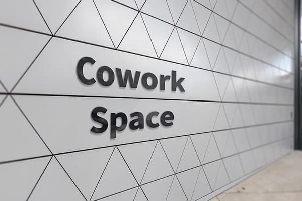 Custom lobby sign with company logo mounted on wall in a modern office reception, Aurora, CO