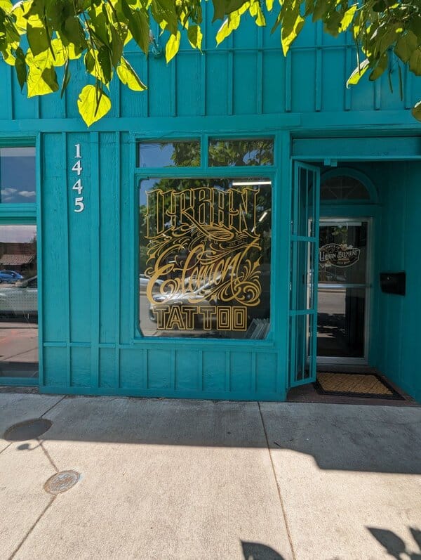 Drive sales with custom window decals on a retail storefront, showcasing business branding, hours, and promotional graphics.