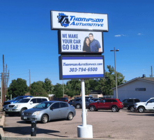 Thompson Automotive commercial building signage after redesign by Mtn High Sign Design, mounted on exterior facade