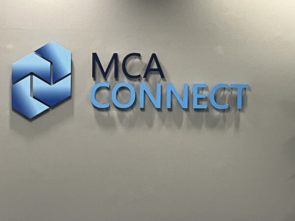 Interior acrylic wall sign showcasing business branding in a sleek, professional office lobby.