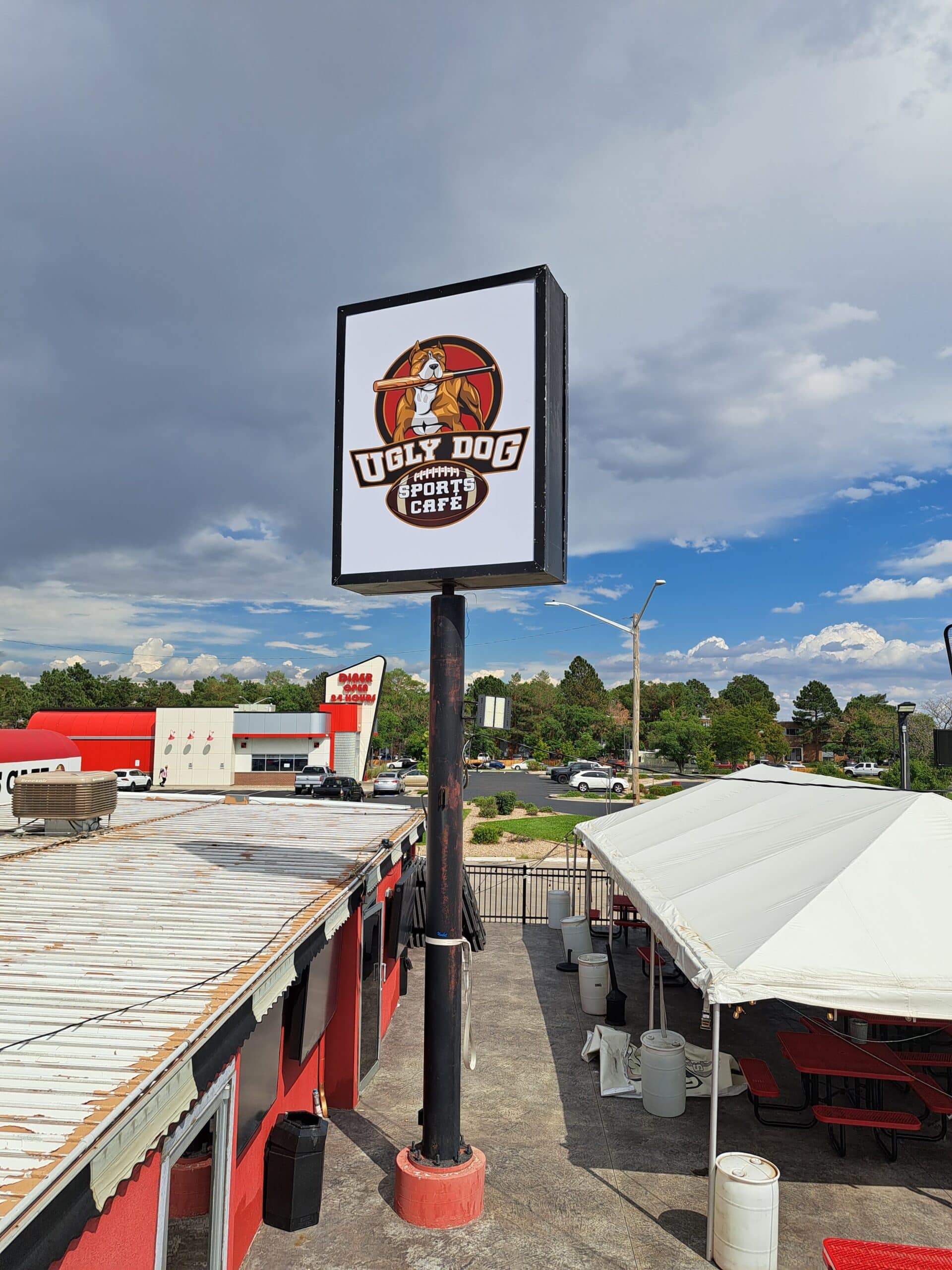 Custom bar sign mounted on wall, bold lettering and graphics on durable material, high-visibility finish
