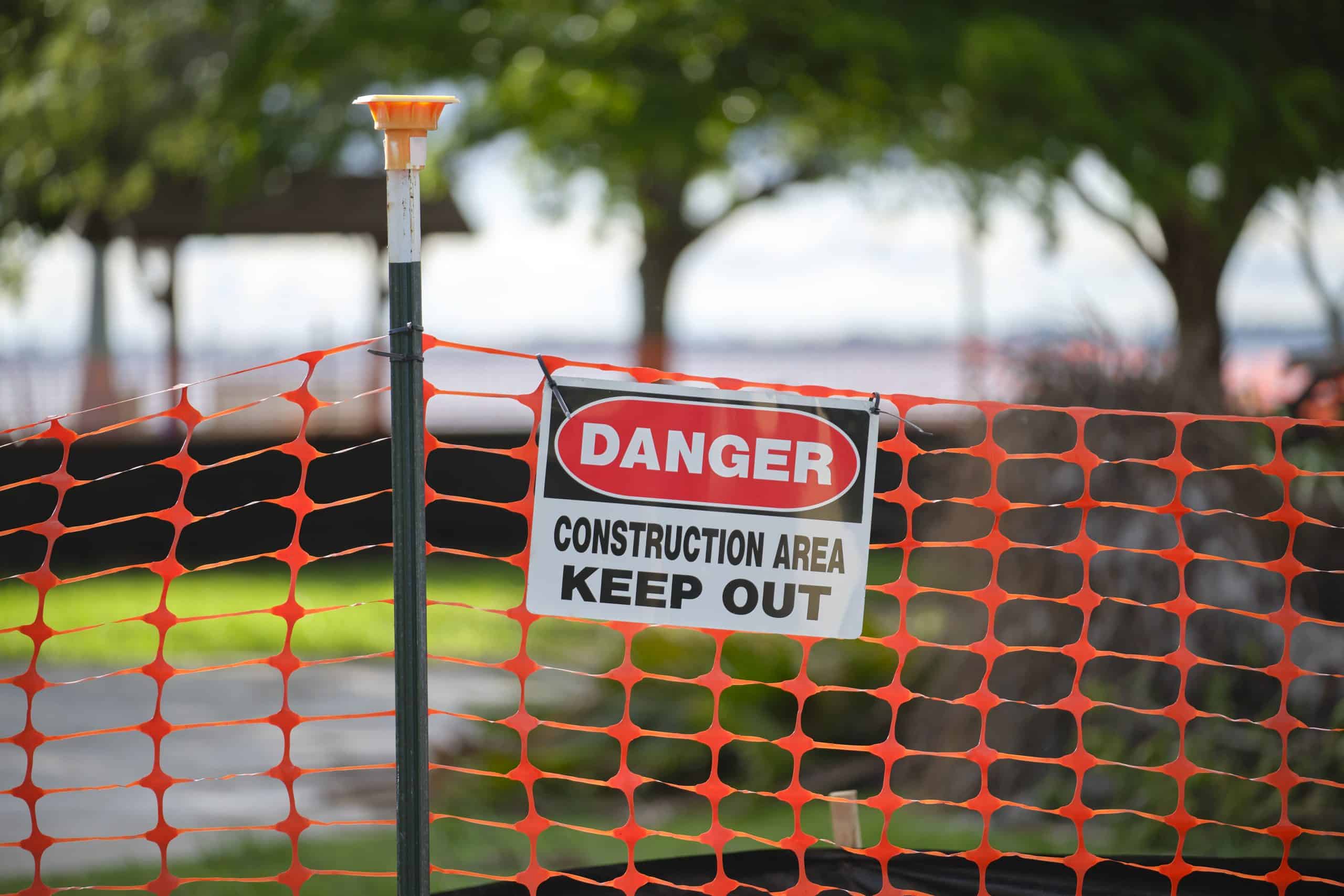 Protective barrier at an active construction site ensuring worker and public safety compliance